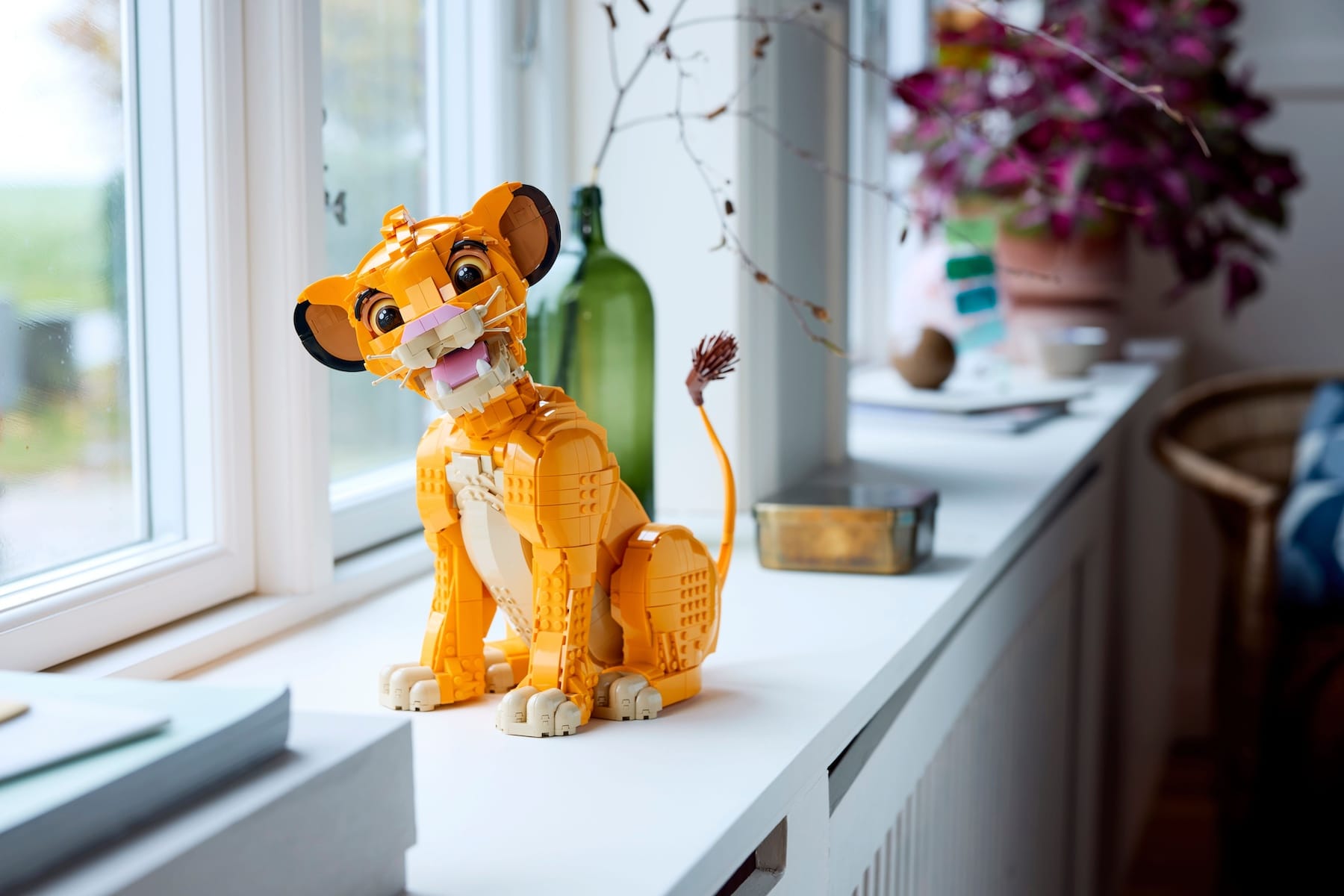A photo of the LEGO Disney Young Simba the Lion King Set for Adults 43247 on a window sill