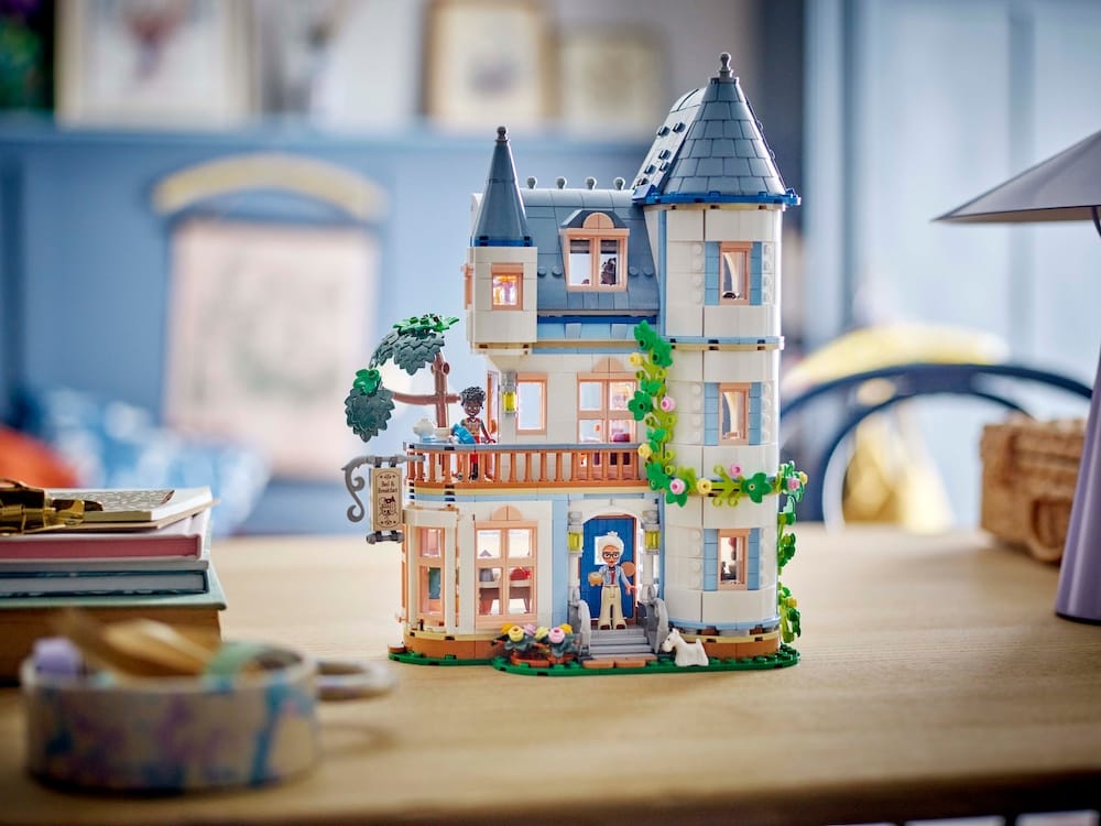 A photo of a white and blue LEGO Disney castle with a fuzzy background