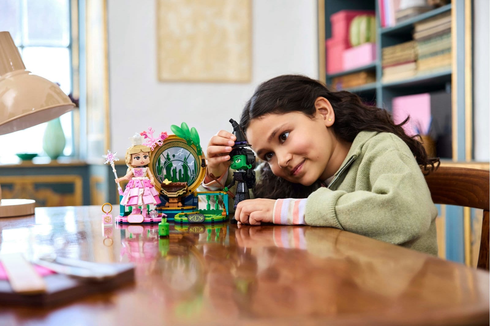 Girl at table playing with LEGO Wicked Elphaba & Glinda Figures Movie Set 75682